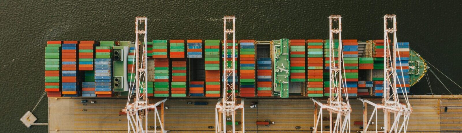 Overhead shot of colorful cargo containers and cranes at Baltimore's bustling port.